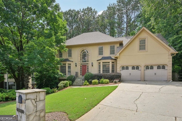 10660 Dunoon Dr, Alpharetta, GA 30022 - view of front of property with stucco siding, driveway, and a front lawn
