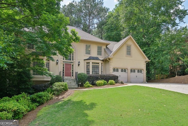 10660 Dunoon Dr, Alpharetta, GA 30022 - view of front of property featuring stucco siding, concrete driveway, and a front yard