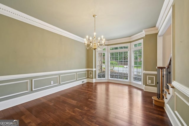 10660 Dunoon Dr, Alpharetta, GA 30022 - unfurnished dining area with a decorative wall, a chandelier, ornamental molding, hardwood / wood-style flooring, and stairway