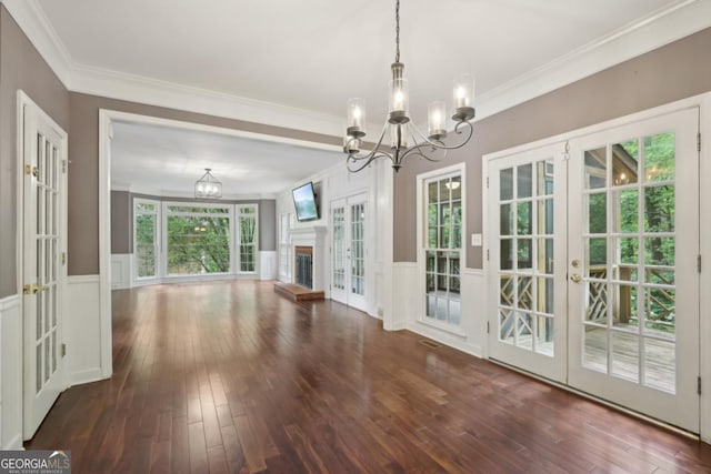 10660 Dunoon Dr, Alpharetta, GA 30022 - unfurnished living room featuring french doors, a chandelier, hardwood / wood-style flooring, a wainscoted wall, and ornamental molding