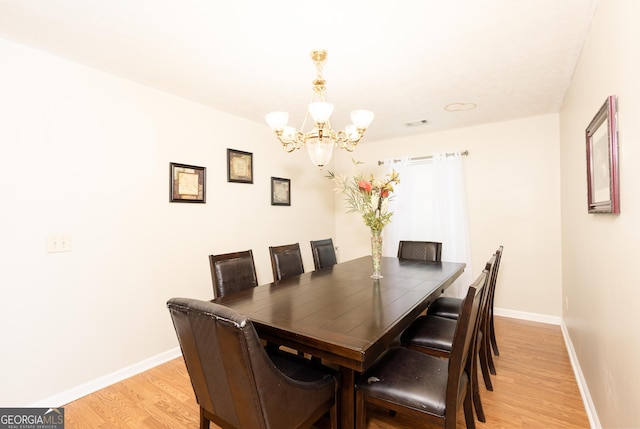 558 Wilder Dr, Columbus, GA 31907 - dining area with a chandelier, light wood-style flooring, and baseboards