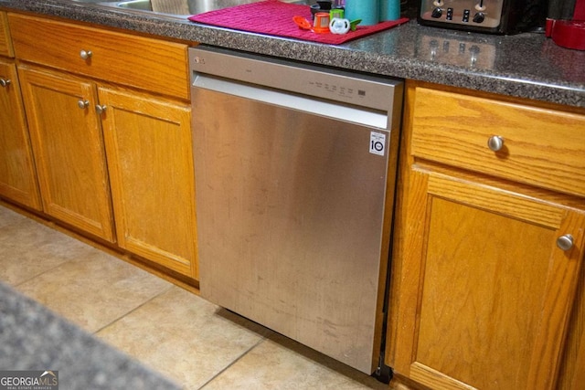 1351 Old Screven Rd, Jesup, GA 31545 - kitchen featuring dishwasher, brown cabinetry, tile patterned floors, and dark countertops