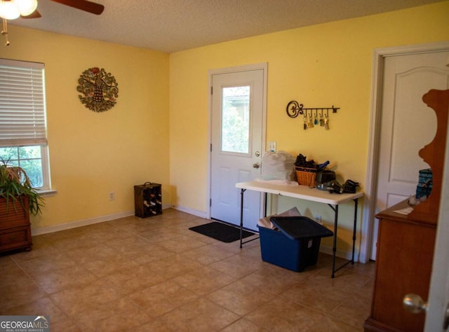 1351 Old Screven Rd, Jesup, GA 31545 - foyer entrance with ceiling fan, a textured ceiling, and light tile patterned floors