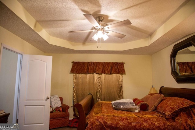 1351 Old Screven Rd, Jesup, GA 31545 - bedroom featuring a textured ceiling, a raised ceiling, and a ceiling fan