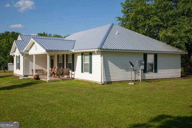 1351 Old Screven Rd, Jesup, GA 31545 - rear view of property featuring a lawn and a metal roof