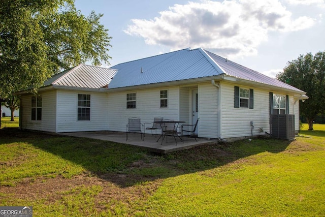 1351 Old Screven Rd, Jesup, GA 31545 - rear view of property featuring metal roof, a patio area, central AC, and a lawn