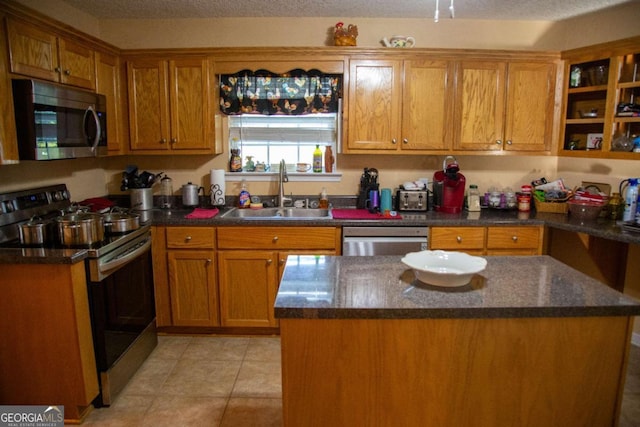 1351 Old Screven Rd, Jesup, GA 31545 - kitchen with appliances with stainless steel finishes, a sink, brown cabinets, and a kitchen island