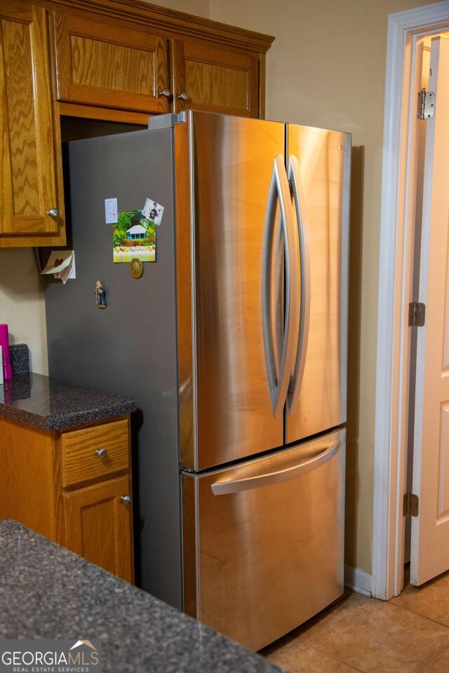 1351 Old Screven Rd, Jesup, GA 31545 - kitchen with freestanding refrigerator, brown cabinetry, and light tile patterned flooring