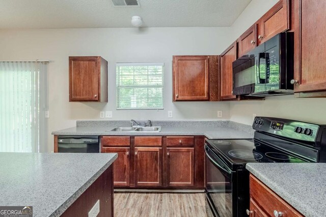 6285 Polar Fox Ct, Riverdale, GA 30296 - kitchen featuring black appliances, light wood finished floors, and light countertops