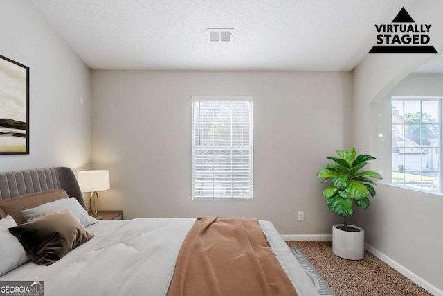 6285 Polar Fox Ct, Riverdale, GA 30296 - carpeted bedroom featuring baseboards and arched walkways