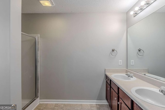 6285 Polar Fox Ct, Riverdale, GA 30296 - bathroom with double vanity, a stall shower, and a textured ceiling
