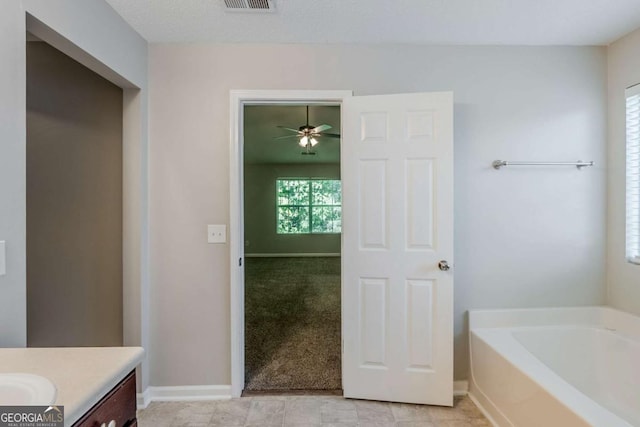 6285 Polar Fox Ct, Riverdale, GA 30296 - bathroom with vanity, a bath, and a ceiling fan