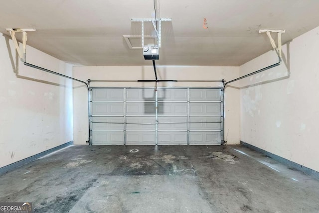 6285 Polar Fox Ct, Riverdale, GA 30296 - garage featuring baseboards and a garage door opener
