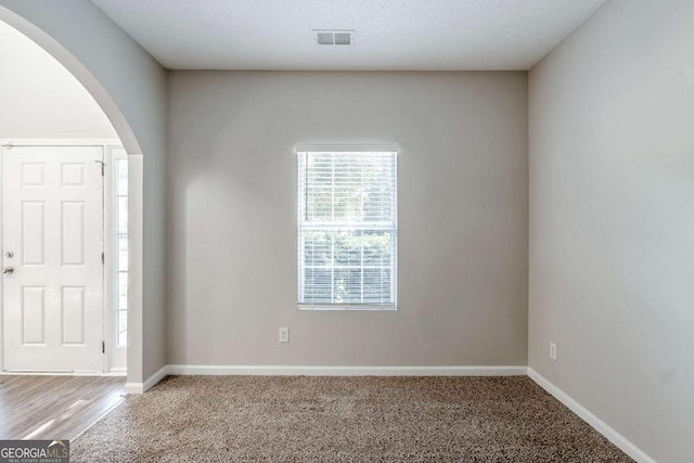 6285 Polar Fox Ct, Riverdale, GA 30296 - foyer entrance featuring arched walkways and carpet flooring