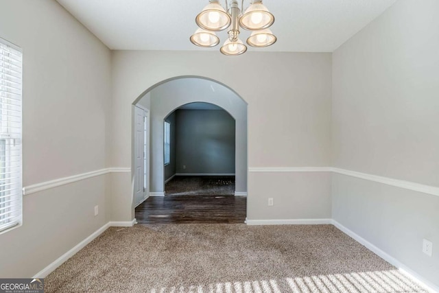 6285 Polar Fox Ct, Riverdale, GA 30296 - spare room featuring carpet, a chandelier, and arched walkways