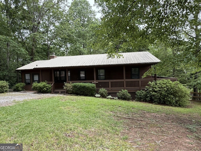 22 Ridge Haven Dr, Cleveland, GA 30528 - view of front facade with a front lawn, a porch, a chimney, and metal roof