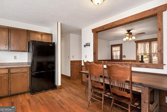 22 Ridge Haven Dr, Cleveland, GA 30528 - kitchen featuring freestanding refrigerator, light wood-style flooring, a ceiling fan, a textured ceiling, and light countertops