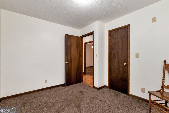 22 Ridge Haven Dr, Cleveland, GA 30528 - unfurnished bedroom featuring carpet, baseboards, and a textured ceiling