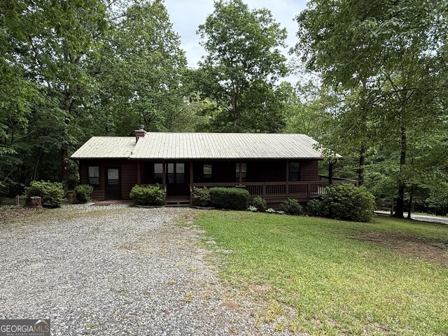 22 Ridge Haven Dr, Cleveland, GA 30528 - view of front of property with a porch, a front lawn, gravel driveway, and a chimney
