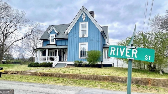 6 River St SW, Cave Spring, GA 30124 - victorian-style house featuring a porch, board and batten siding, a front yard, and roof with shingles