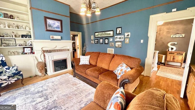 6 River St SW, Cave Spring, GA 30124 - living area with wood finished floors, a fireplace, built in features, a chandelier, and a towering ceiling