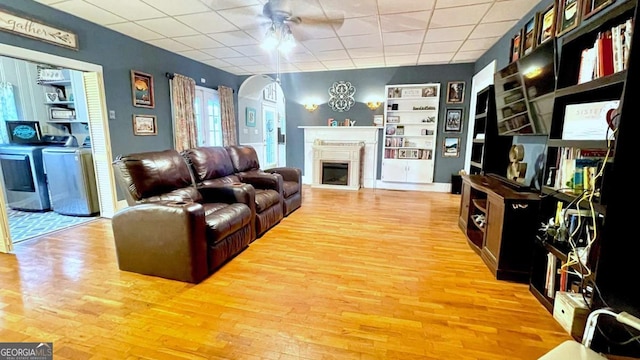6 River St SW, Cave Spring, GA 30124 - living room featuring arched walkways, light wood finished floors, ceiling fan, a paneled ceiling, and built in features