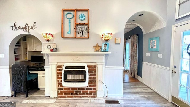 6 River St SW, Cave Spring, GA 30124 - living room featuring heating unit, light wood-type flooring, a wainscoted wall, and a desk