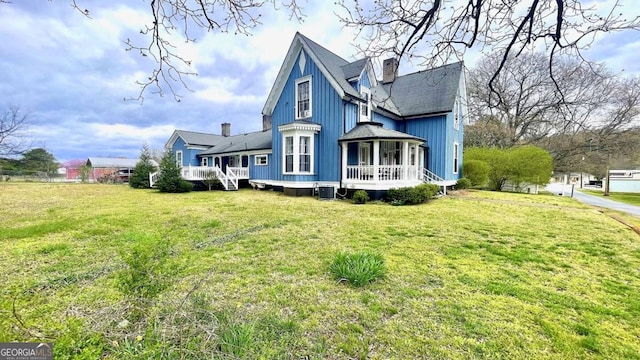 6 River St SW, Cave Spring, GA 30124 - view of side of property with a wooden deck, a yard, a chimney, central AC unit, and a shingled roof