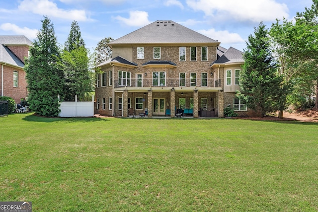 back of house featuring brick siding, french doors, and a patio