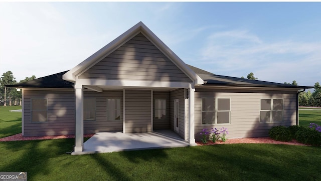 back of property featuring a lawn and a patio