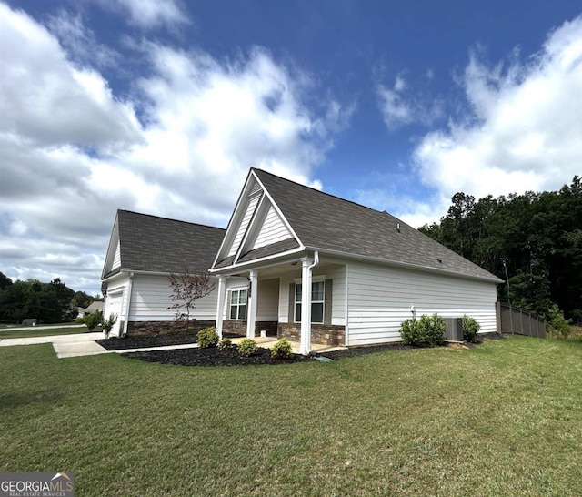 118 Garrett Dr, Eatonton, GA 31024 - view of side of property with covered porch, an attached garage, roof with shingles, and stone siding