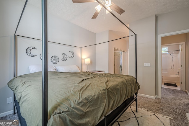 bedroom with carpet, baseboards, a textured ceiling, and ensuite bathroom