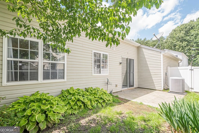 back of house featuring a patio, central AC, and fence