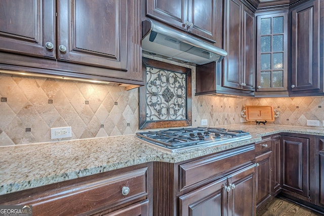 2295 Falmouth Ct SE Unit 23, Smyrna, GA 30080 - kitchen featuring under cabinet range hood, stainless steel gas cooktop, dark brown cabinets, glass insert cabinets, and decorative backsplash