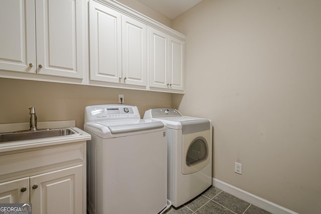 2295 Falmouth Ct SE Unit 23, Smyrna, GA 30080 - washroom with cabinet space, washing machine and clothes dryer, and dark tile patterned flooring