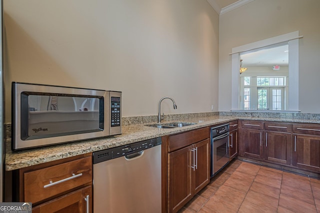 2295 Falmouth Ct SE Unit 23, Smyrna, GA 30080 - kitchen featuring appliances with stainless steel finishes, crown molding, light stone counters, and light tile patterned flooring