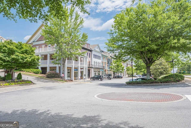 2295 Falmouth Ct SE Unit 23, Smyrna, GA 30080 - view of asphalt road featuring curbs, a residential view, and street lighting
