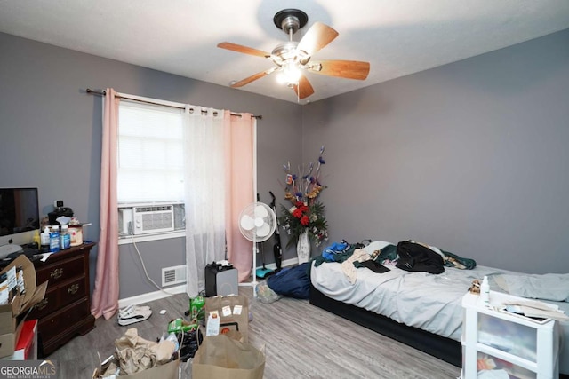 377 Black Oak Ct, Lawrenceville, GA 30046 - bedroom with wood finished floors, cooling unit, a ceiling fan, and baseboards