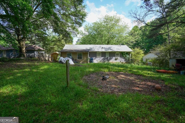 377 Black Oak Ct, Lawrenceville, GA 30046 - rear view of property with a storage shed, an outbuilding, and a yard