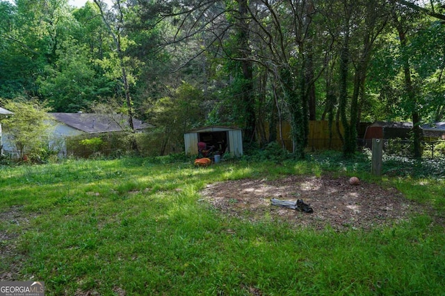 377 Black Oak Ct, Lawrenceville, GA 30046 - view of yard with a shed, fence, an outdoor structure, and a forest view