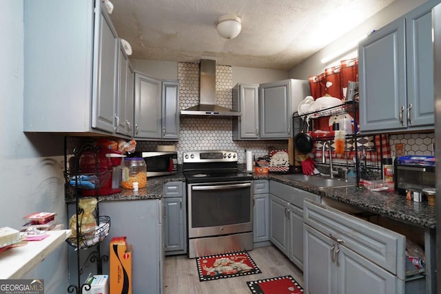 377 Black Oak Ct, Lawrenceville, GA 30046 - kitchen featuring appliances with stainless steel finishes, wall chimney exhaust hood, gray cabinets, a sink, and light wood-type flooring