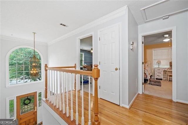1763 Benningfield Dr SW, Marietta, GA 30064 - hallway featuring an upstairs landing, light wood-style floors, baseboards, crown molding, and a chandelier
