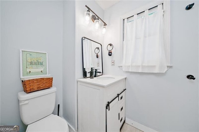 1763 Benningfield Dr SW, Marietta, GA 30064 - bathroom featuring toilet, vanity, and baseboards