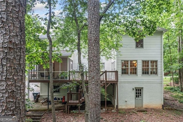 1763 Benningfield Dr SW, Marietta, GA 30064 - rear view of property with a deck, a patio area, brick siding, and a sunroom