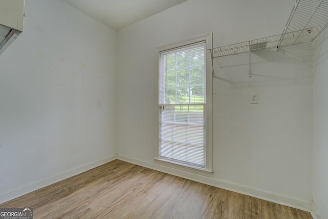 walk in closet with light wood-style flooring