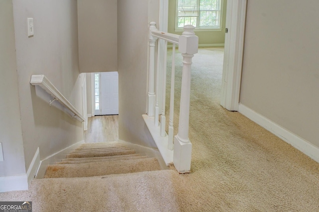 stairway with carpet floors and baseboards