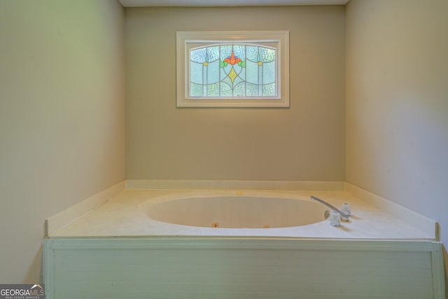 bathroom featuring a tub with jets