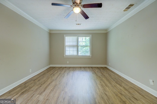 unfurnished room featuring wood finished floors, baseboards, crown molding, and a ceiling fan