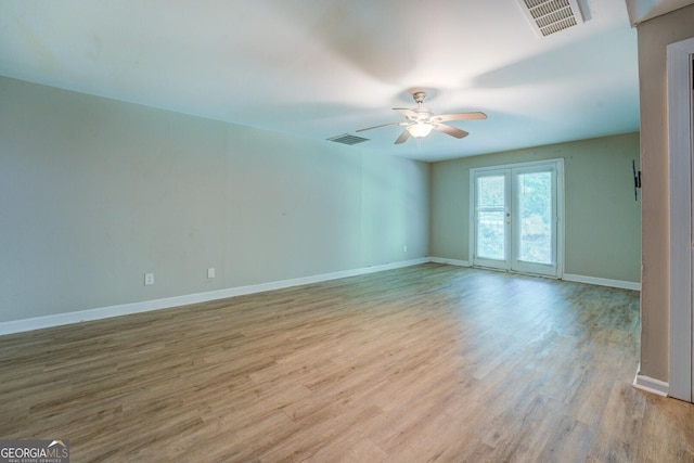unfurnished room with wood finished floors, ceiling fan, and baseboards