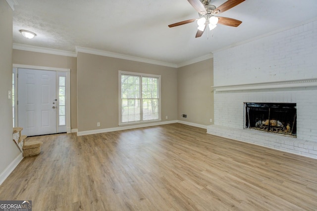 unfurnished living room featuring wood finished floors, a ceiling fan, baseboards, and crown molding